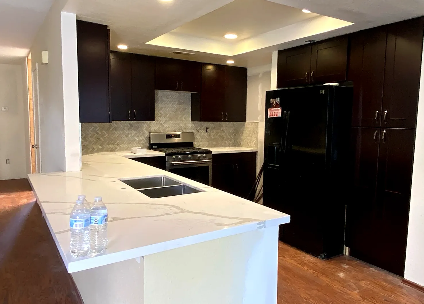 Kitchen with dark cabinets and white quartz counters
